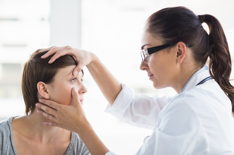 Doctor examining a patient's eye for infection, focusing on eye health and treatment options.