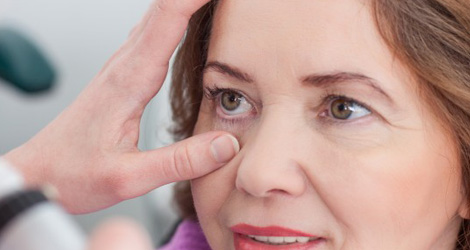 Eye examination with a healthcare professional checking a woman's eye, highlighting the importance of eye care and common eye problems.